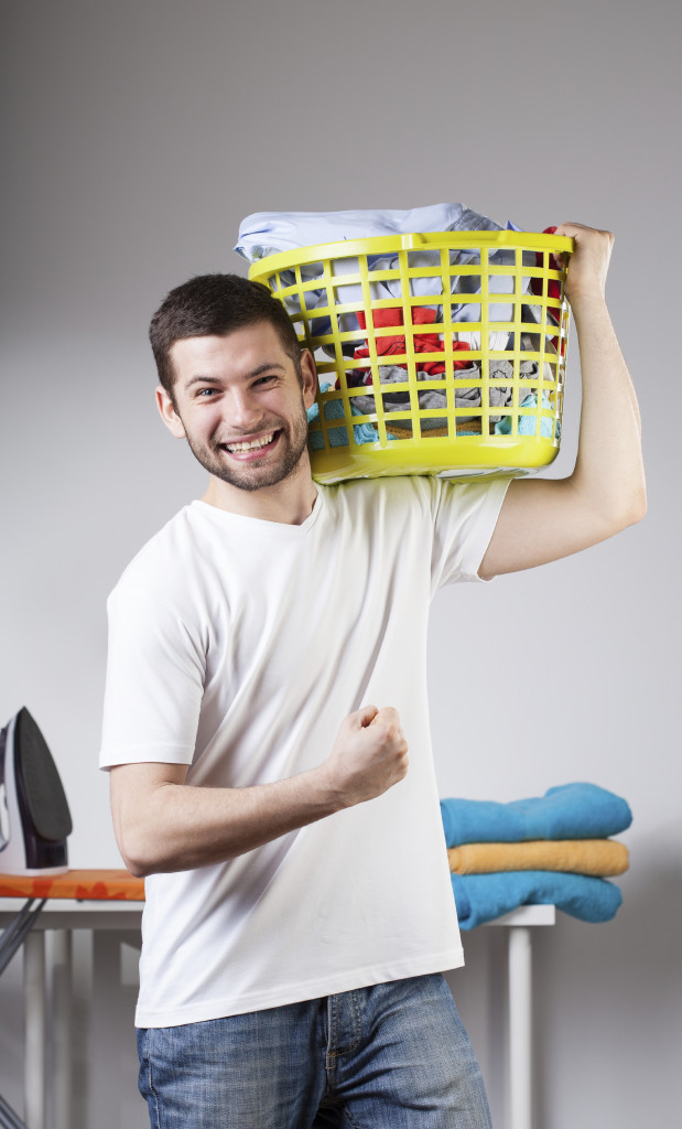 Man beeing proud because he just has done laundry by himself