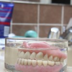 Artificial denture in a glass